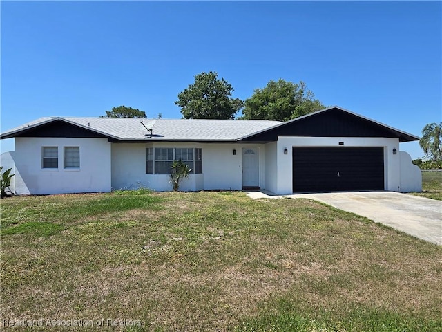 single story home with a garage, a front yard, concrete driveway, and stucco siding