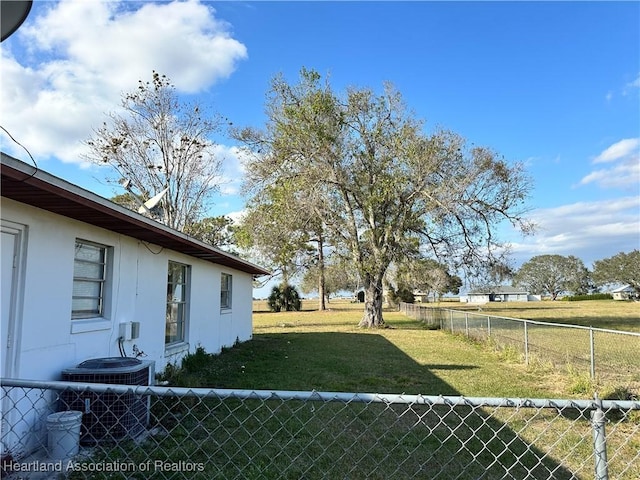 view of yard with central air condition unit and fence private yard