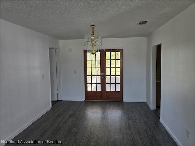 interior space with a notable chandelier, baseboards, dark wood-style flooring, and french doors