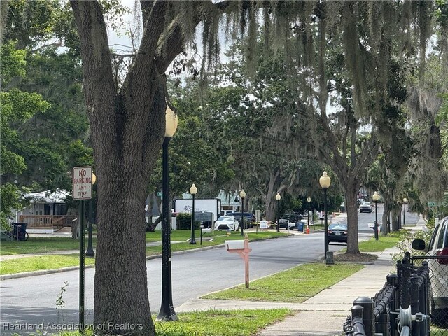351 N Commerce Ave, Sebring, FL 33870 - view of asphalt street with sidewalks, street lights, curbs, and traffic signs