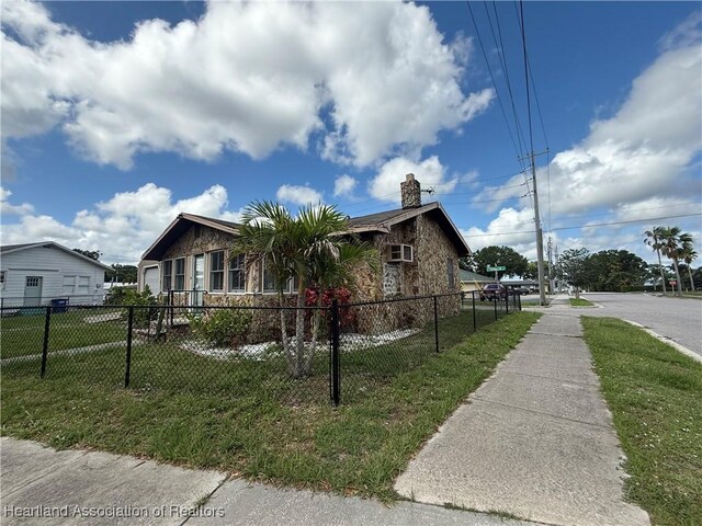351 N Commerce Ave, Sebring, FL 33870 - view of front of house with a chimney and stone siding