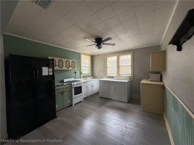 351 N Commerce Ave, Sebring, FL 33870 - kitchen featuring black refrigerator with ice dispenser, white gas stove, separate washer and dryer, a ceiling fan, and hardwood / wood-style flooring