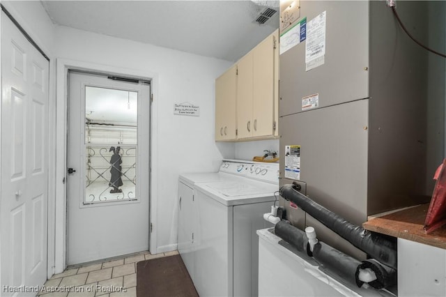 2407 Par Rd, Sebring, FL 33872 - washroom featuring cabinet space, visible vents, washer and dryer, and light tile patterned flooring