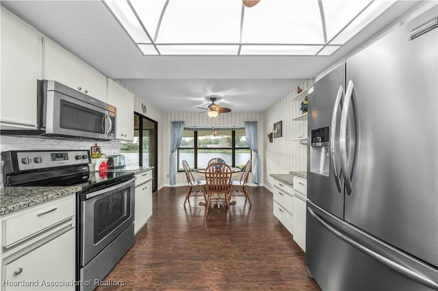 2407 Par Rd, Sebring, FL 33872 - kitchen with ceiling fan, dark wood-style floors, white cabinetry, and appliances with stainless steel finishes