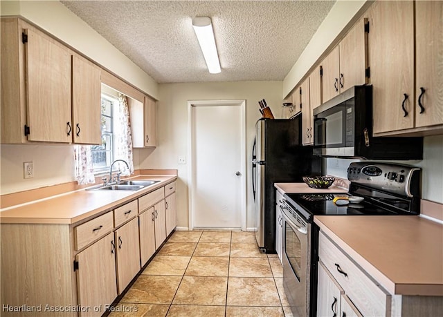 kitchen with sink, light tile patterned floors, stainless steel appliances, a textured ceiling, and light brown cabinets