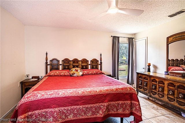 bedroom with light tile patterned flooring, ceiling fan, and a textured ceiling