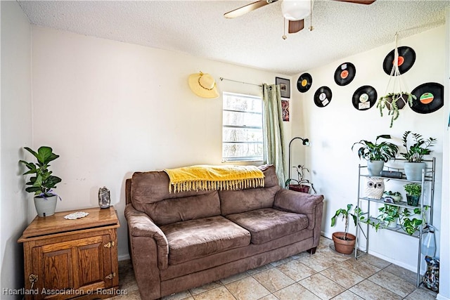 living room with ceiling fan and a textured ceiling