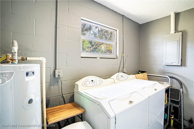 washroom with independent washer and dryer, electric panel, and water heater