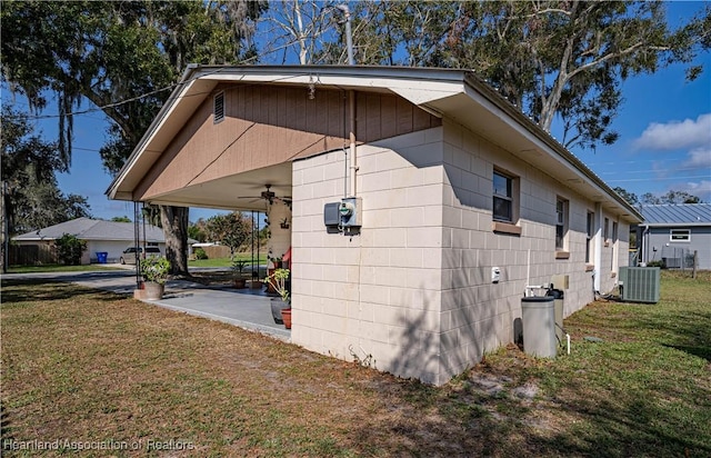 view of side of property featuring central AC unit, a yard, a patio, and ceiling fan