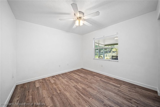 unfurnished room with baseboards, ceiling fan, and wood finished floors