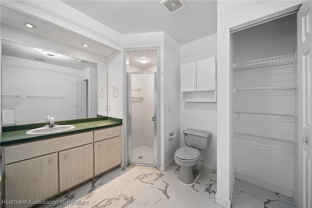 full bathroom with vanity, toilet, marble finish floor, visible vents, and a stall shower