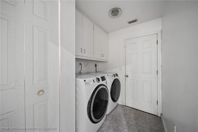 laundry room featuring independent washer and dryer, baseboards, visible vents, and cabinet space