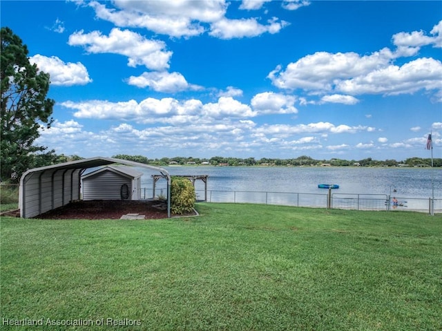 view of yard with a water view and a carport