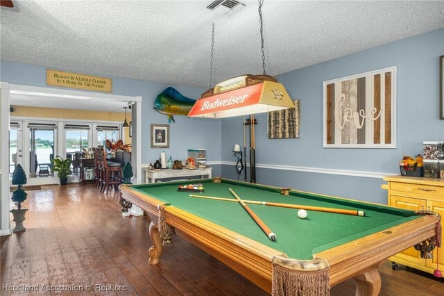 playroom featuring dark wood-type flooring, a textured ceiling, and billiards