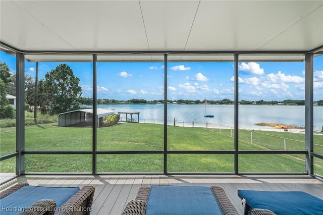 unfurnished sunroom with a water view