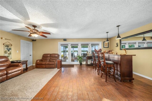 interior space featuring a textured ceiling, dark hardwood / wood-style flooring, and french doors