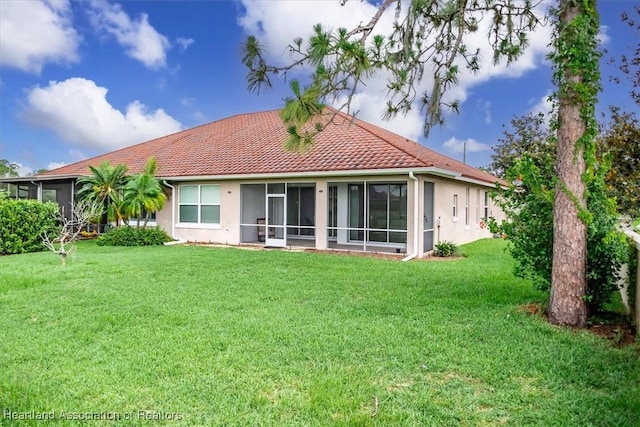 6831 Sun Blvd N, Sebring, FL 33872 - rear view of house with a sunroom, stucco siding, a lawn, and a tiled roof