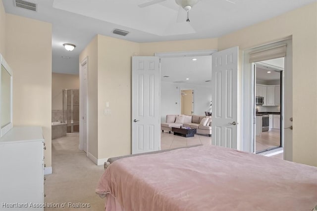 6831 Sun Blvd N, Sebring, FL 33872 - bedroom with baseboards, recessed lighting, connected bathroom, and light colored carpet