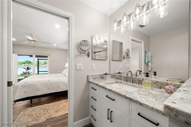 2 Chickasaw St, Lake Placid, FL 33852 - bathroom featuring baseboards, ensuite bathroom, wood finished floors, vanity, and a ceiling fan