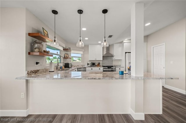 2 Chickasaw St, Lake Placid, FL 33852 - kitchen with a sink, appliances with stainless steel finishes, wall chimney exhaust hood, light stone countertops, and hanging light fixtures