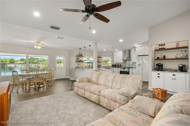 2 Chickasaw St, Lake Placid, FL 33852 - living room with visible vents, lofted ceiling, wood finished floors, and a ceiling fan