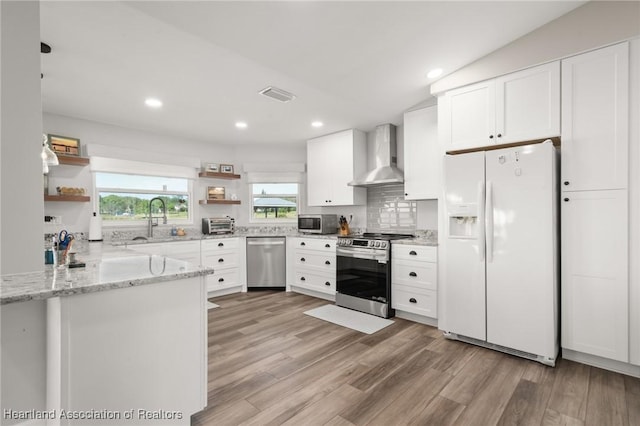 2 Chickasaw St, Lake Placid, FL 33852 - kitchen featuring visible vents, open shelves, a sink, stainless steel appliances, and wall chimney range hood