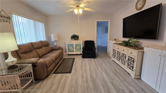 living room featuring light wood-type flooring and ceiling fan