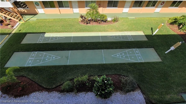 view of property's community featuring a yard