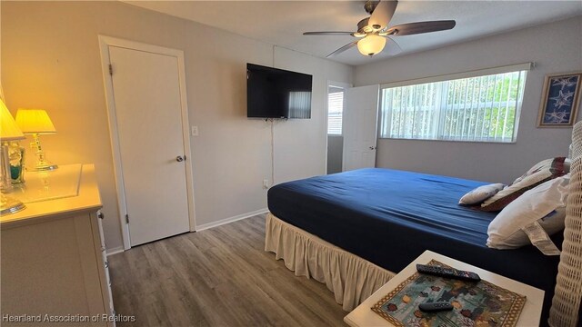 bedroom with hardwood / wood-style floors and ceiling fan