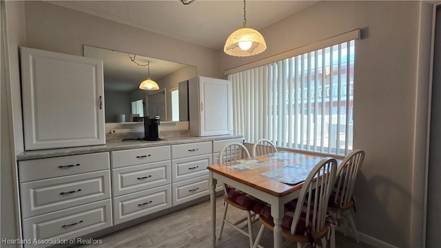 dining area with light hardwood / wood-style floors and plenty of natural light