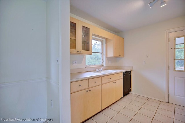 kitchen featuring light tile patterned floors, a sink, light countertops, glass insert cabinets, and dishwasher