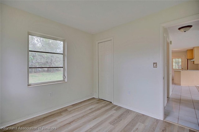 empty room featuring baseboards and light wood-style floors