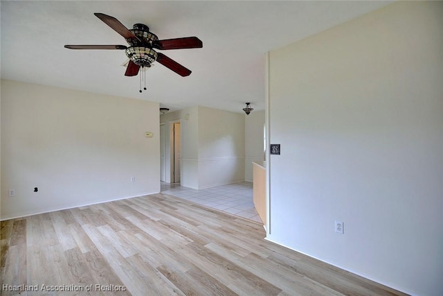 empty room featuring light wood finished floors and ceiling fan