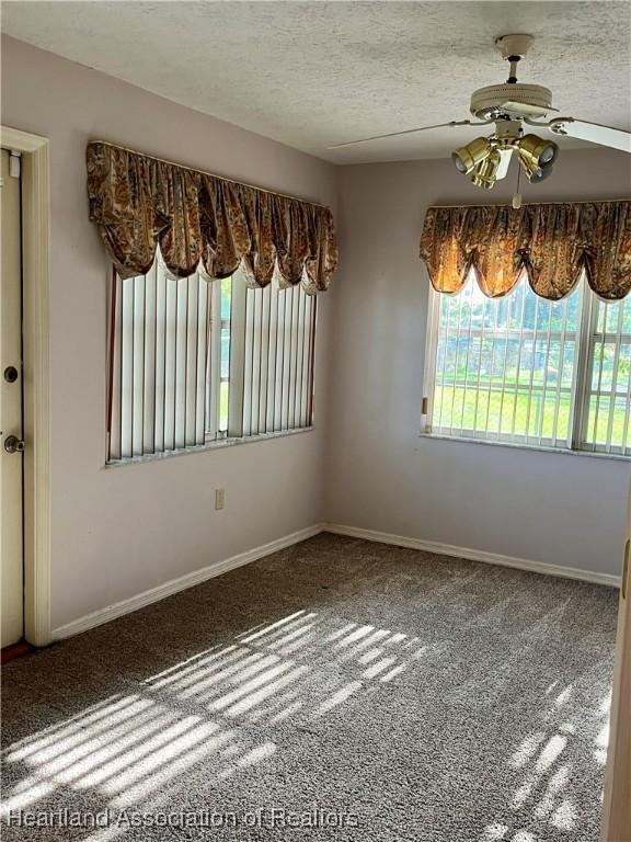 2527 Davis Cir, Sebring, FL 33870 - empty room featuring carpet, ceiling fan, baseboards, and a textured ceiling