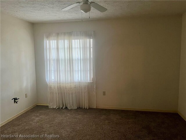 2527 Davis Cir, Sebring, FL 33870 - spare room featuring carpet flooring, a ceiling fan, a textured ceiling, and baseboards
