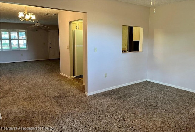 2527 Davis Cir, Sebring, FL 33870 - spare room featuring a chandelier, dark colored carpet, baseboards, and ceiling fan
