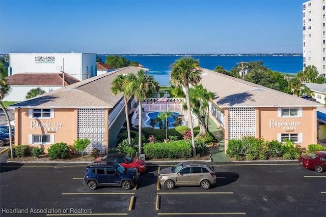 exterior space featuring a water view and uncovered parking