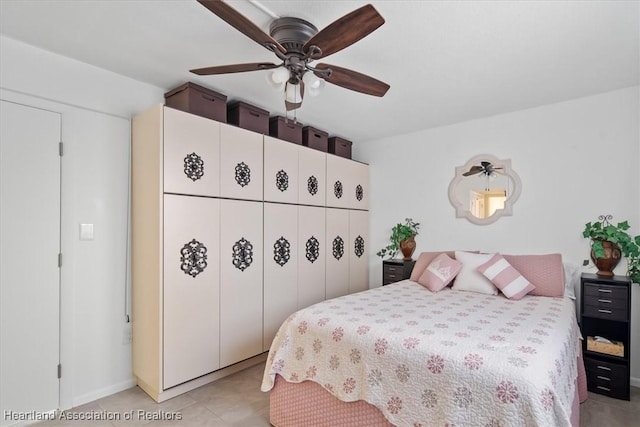 bedroom featuring a ceiling fan and light tile patterned floors