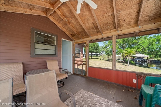 unfurnished sunroom featuring ceiling fan and vaulted ceiling