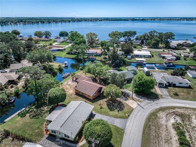 drone / aerial view featuring a residential view and a water view