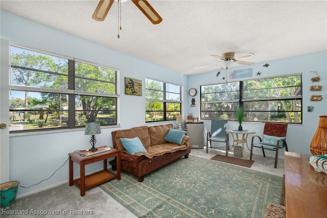 sunroom / solarium featuring a ceiling fan