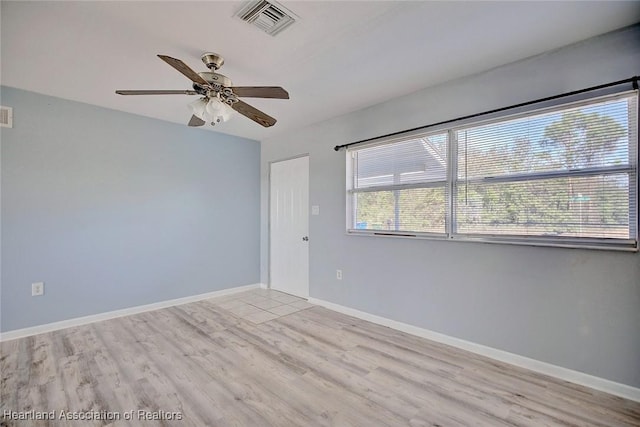 empty room featuring ceiling fan and light wood-type flooring