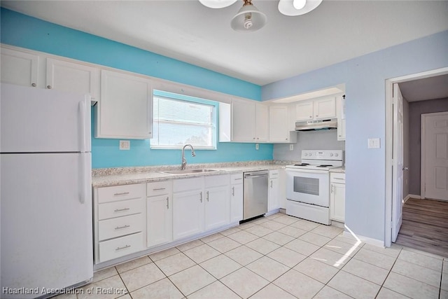 kitchen with sink, white cabinets, light tile patterned flooring, and white appliances