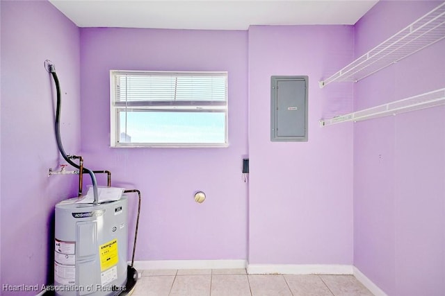 laundry room featuring light tile patterned floors, electric panel, and water heater