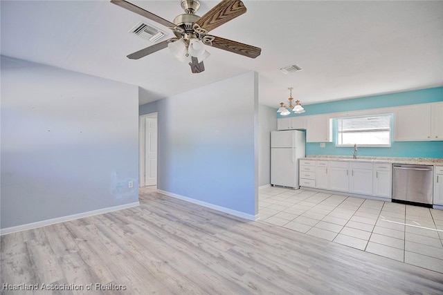 kitchen featuring white cabinetry, sink, stainless steel dishwasher, white refrigerator, and light hardwood / wood-style floors