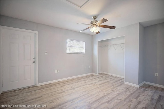 unfurnished bedroom with ceiling fan, a closet, and light wood-type flooring