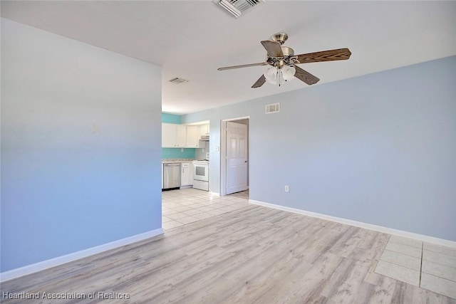 spare room featuring light hardwood / wood-style flooring and ceiling fan