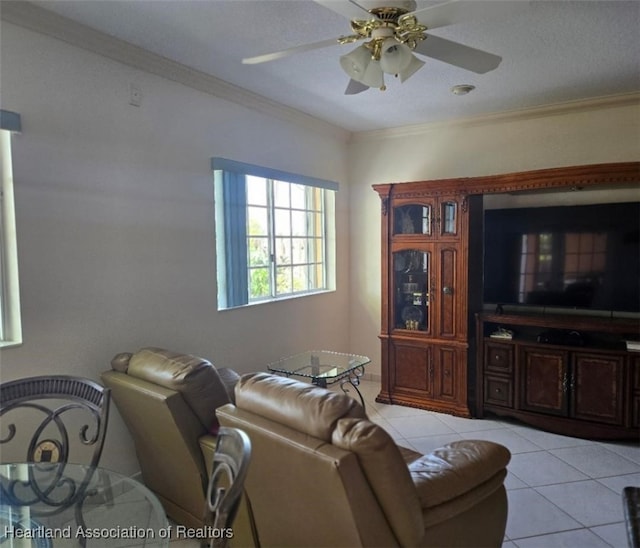 living area featuring a ceiling fan, ornamental molding, and light tile patterned flooring
