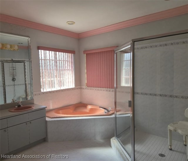 bathroom featuring a garden tub, tile patterned floors, a stall shower, and vanity