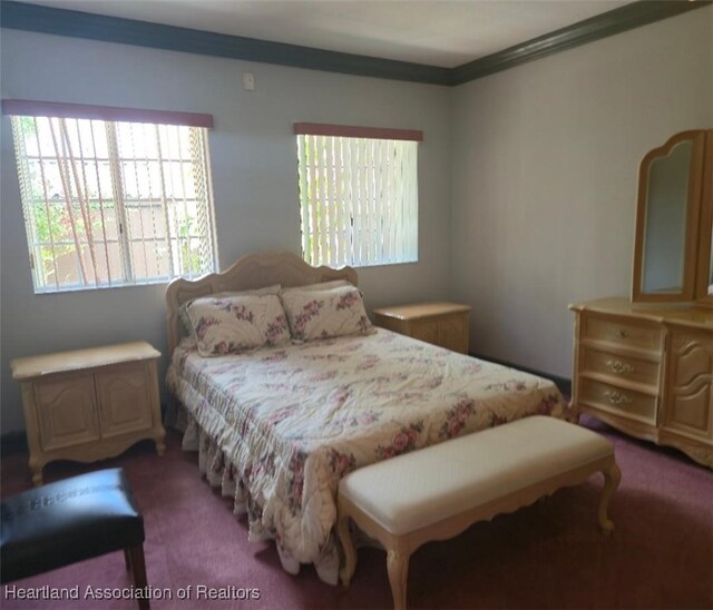 carpeted bedroom featuring crown molding